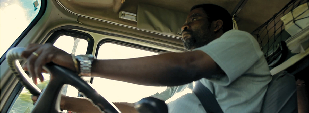 a man at the wheel of a truck