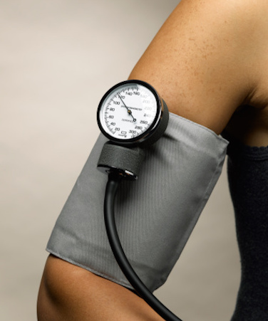 Arm with blood pressure reader wrapped around it