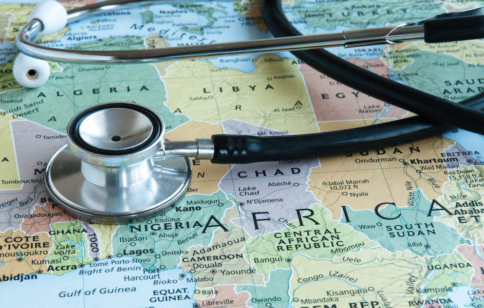 Close up of a stethoscope set on top of a colorful map of Africa