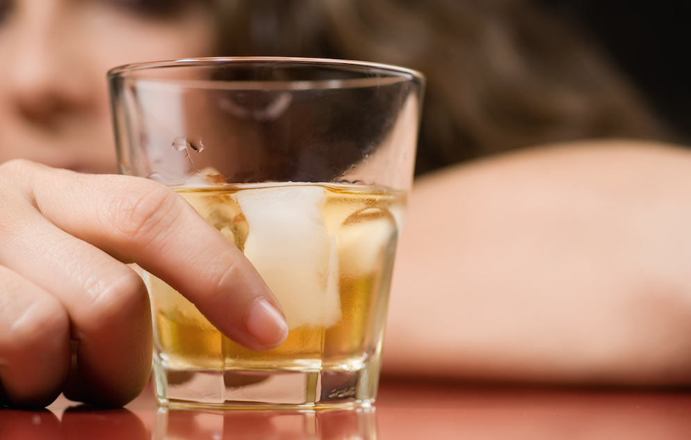 Woman holding a glass of whiskey