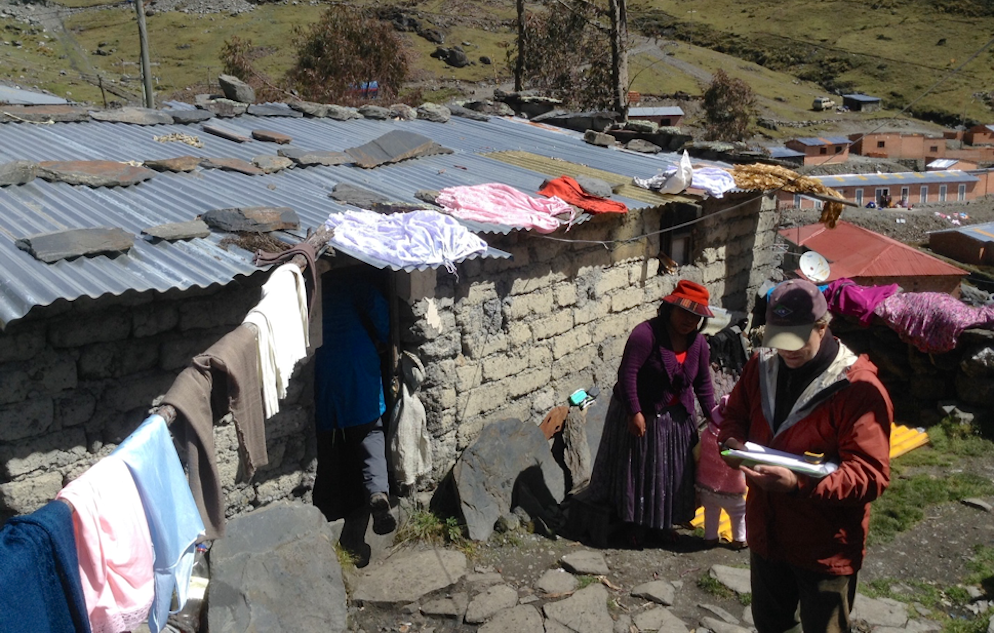 Glen Johnson taking notes outside a residence at a mine site