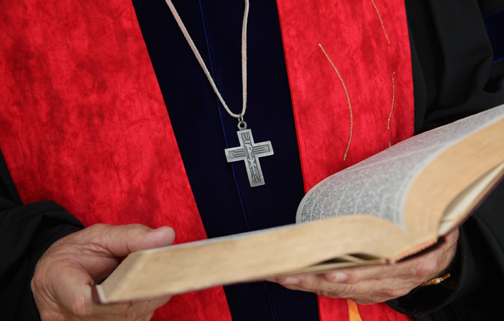 Minister holding Bible