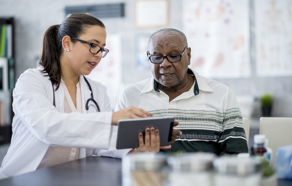 Doctor With A Tablet Computer talking to a patient