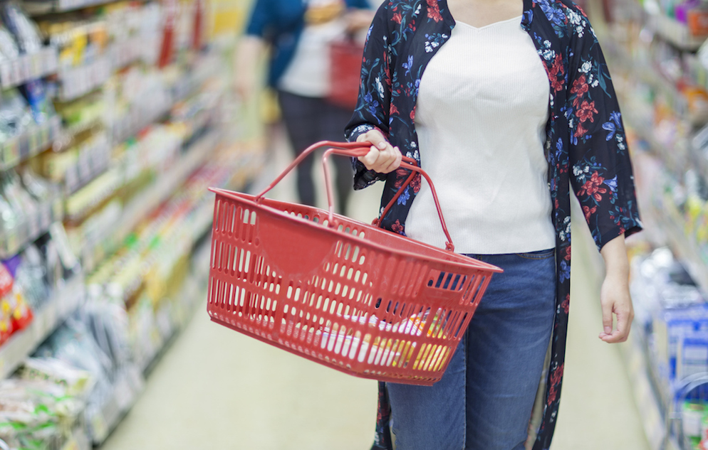 Person grocery shopping with basket