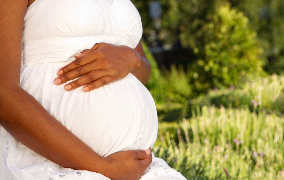 Pregnant woman holding her belly