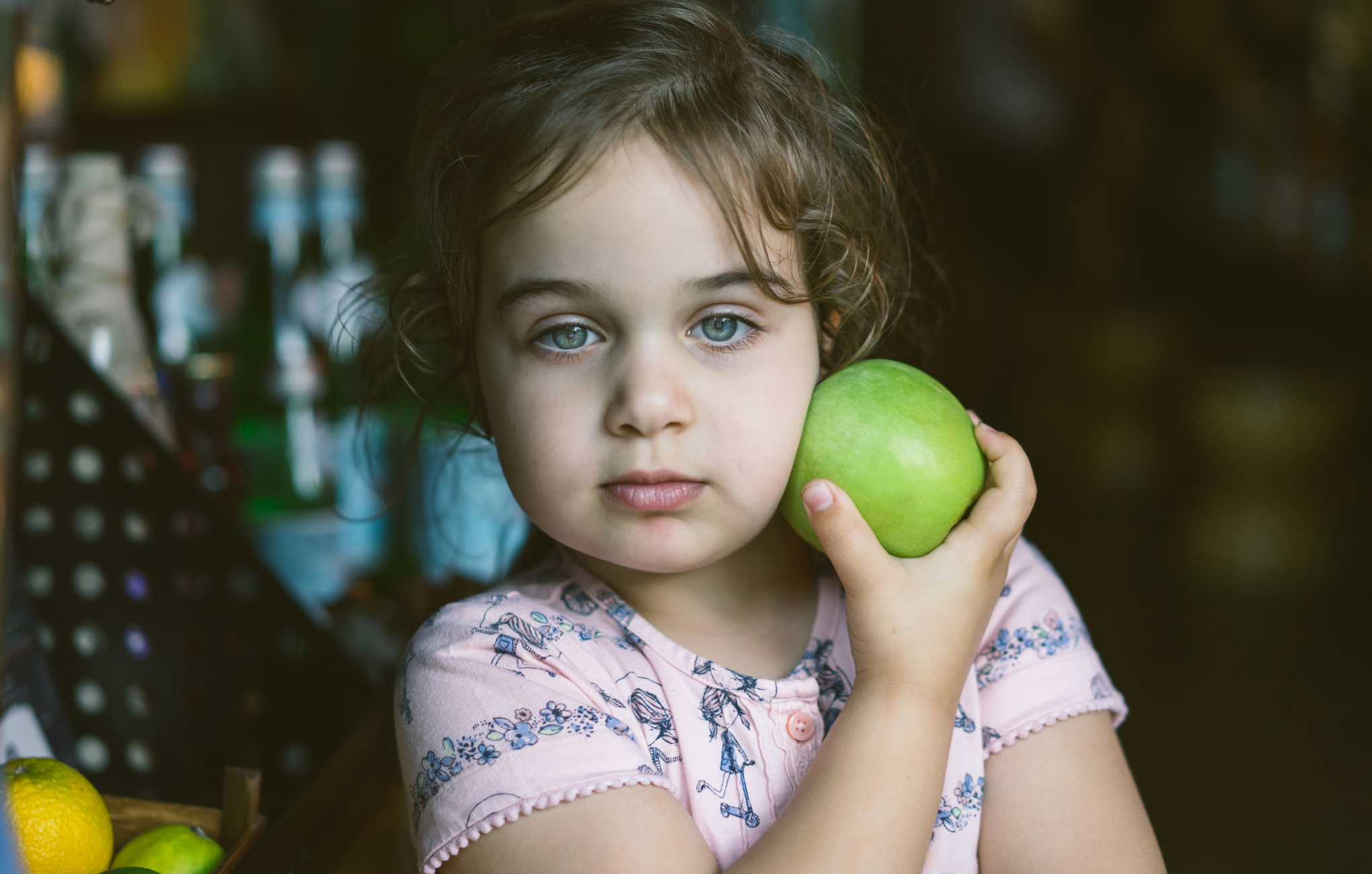 young girl with green apple