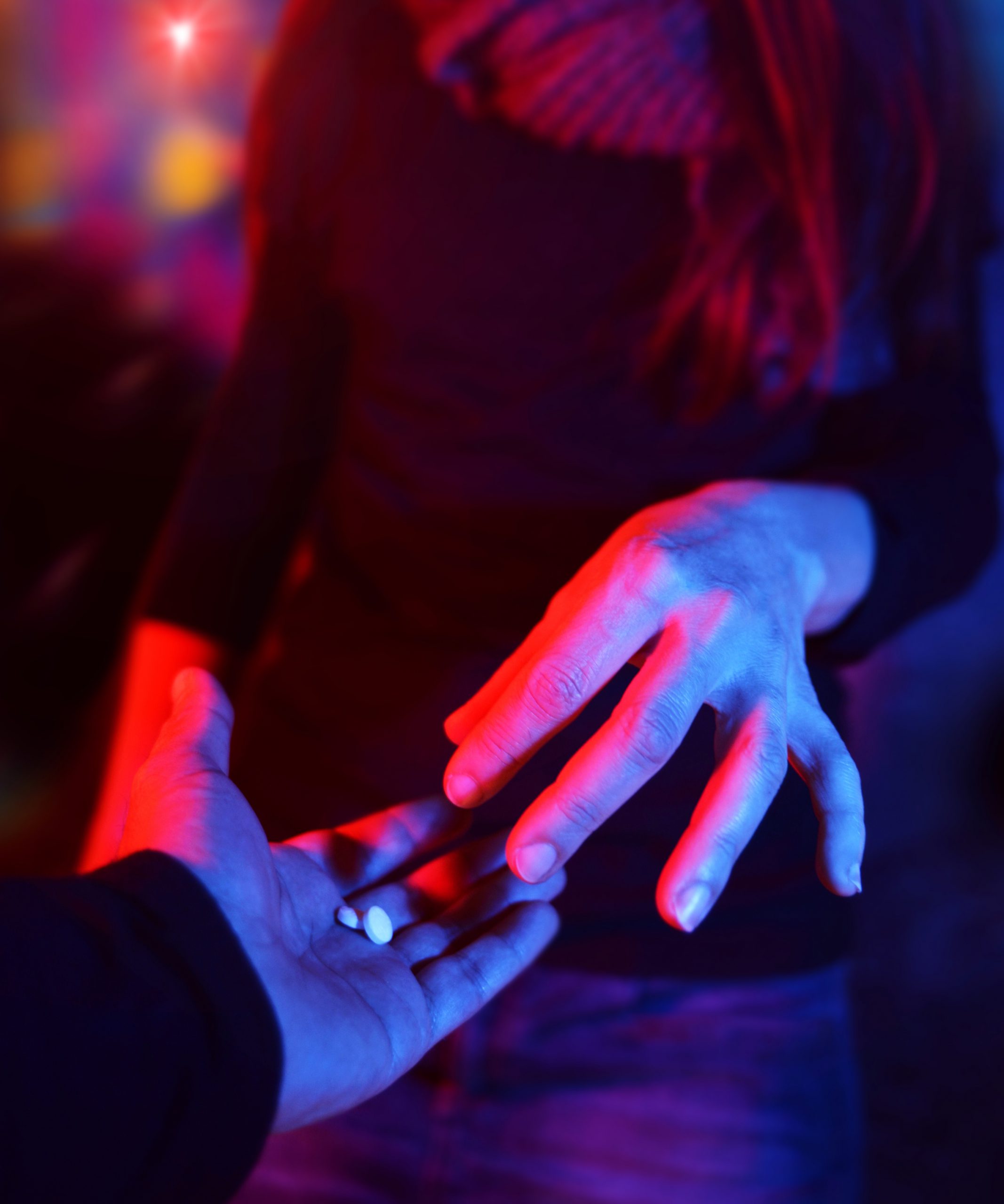 woman in club accepting pills from man
