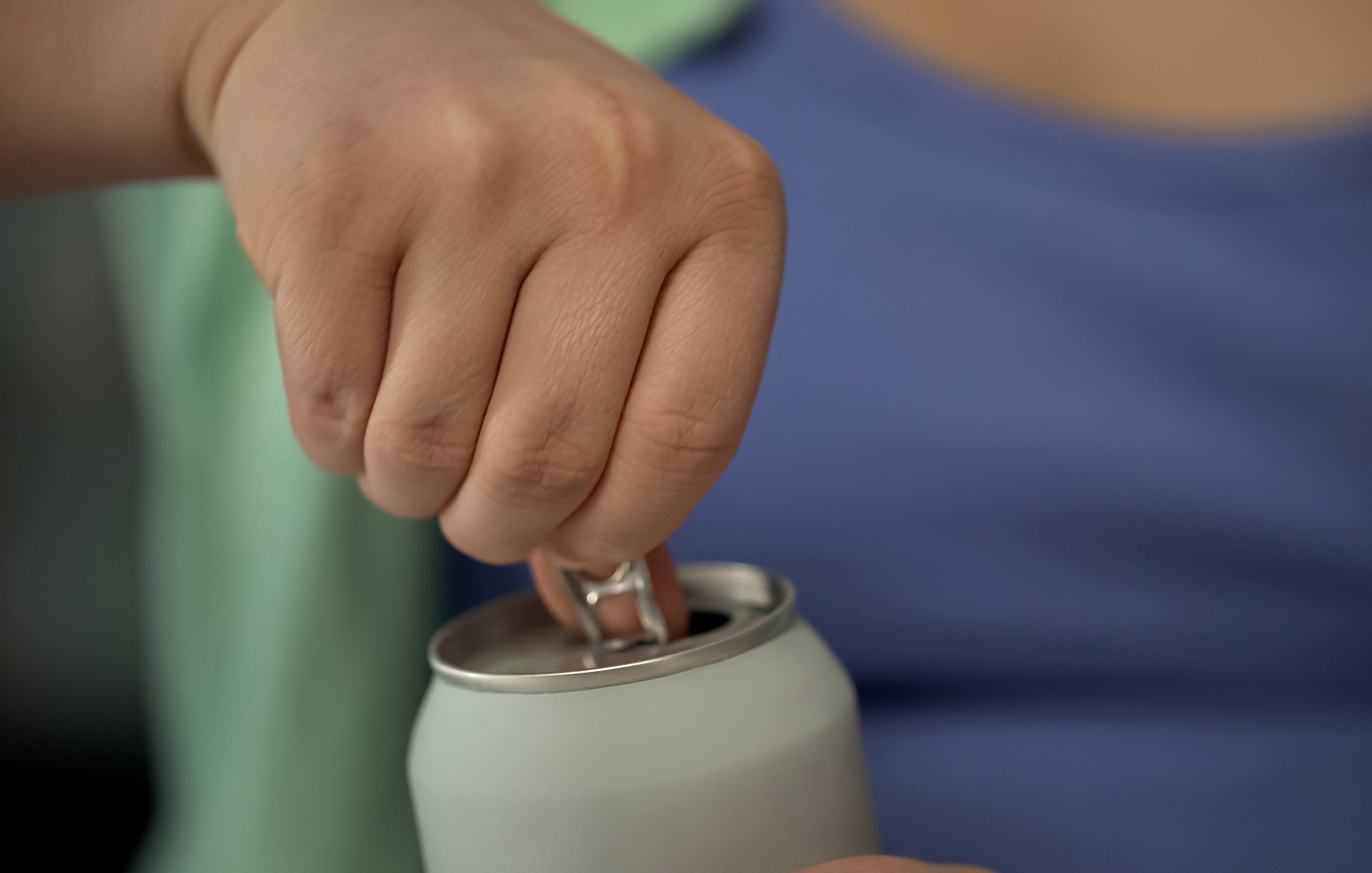 Latina opening can of soda