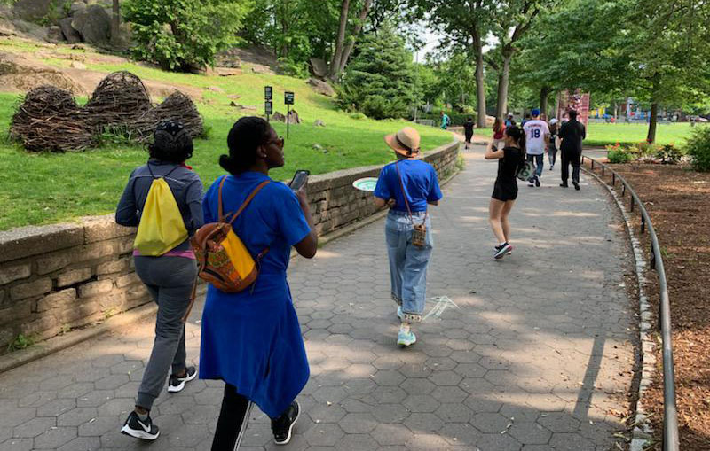 Hikers admiring art in Marcus Garvey park