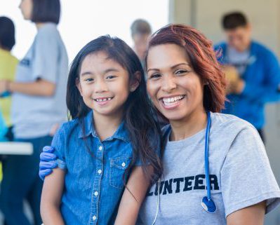 Volunteer doctor and child at community health fair