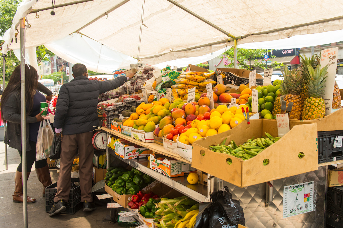 A fruit vendor sells to a customer