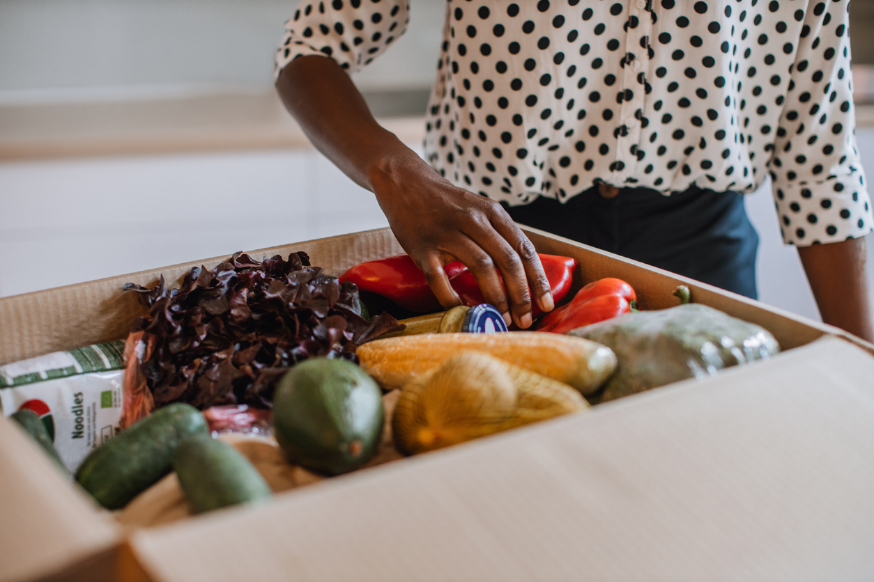 woman opening boxed groceries