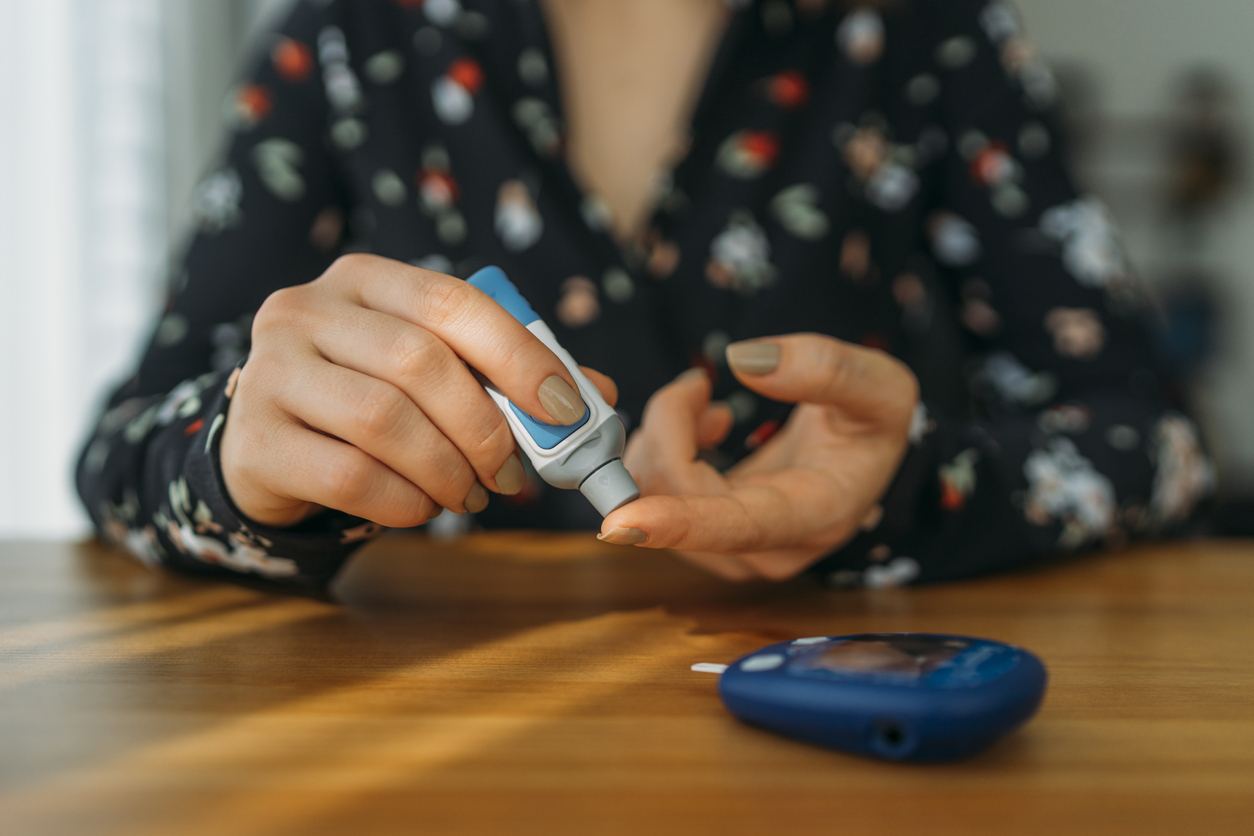 Diabetic woman measuring blood sugar