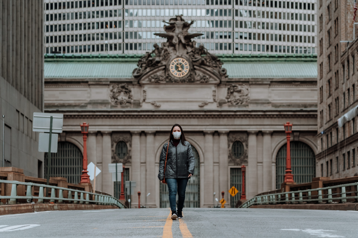 Woman wearing face mask walking in front of Grand Central Station in NYC