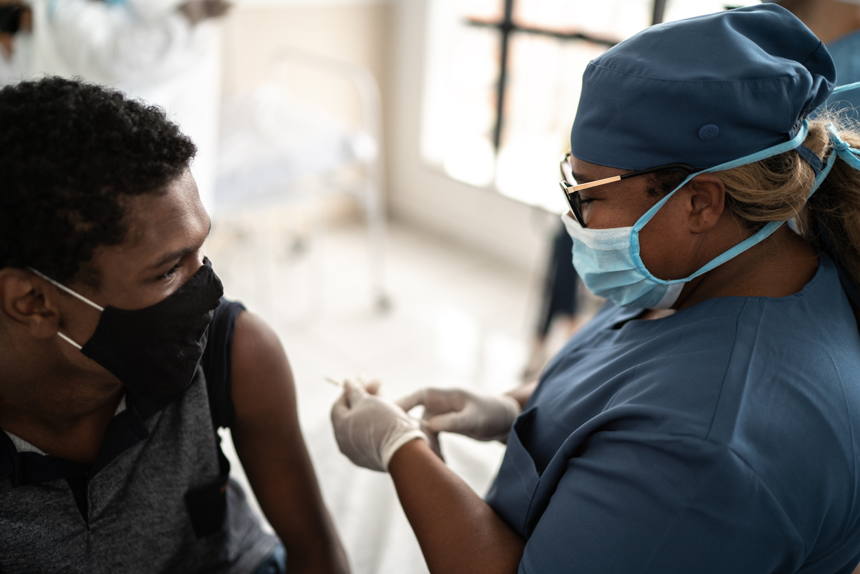 Teenage boy being vaccinated