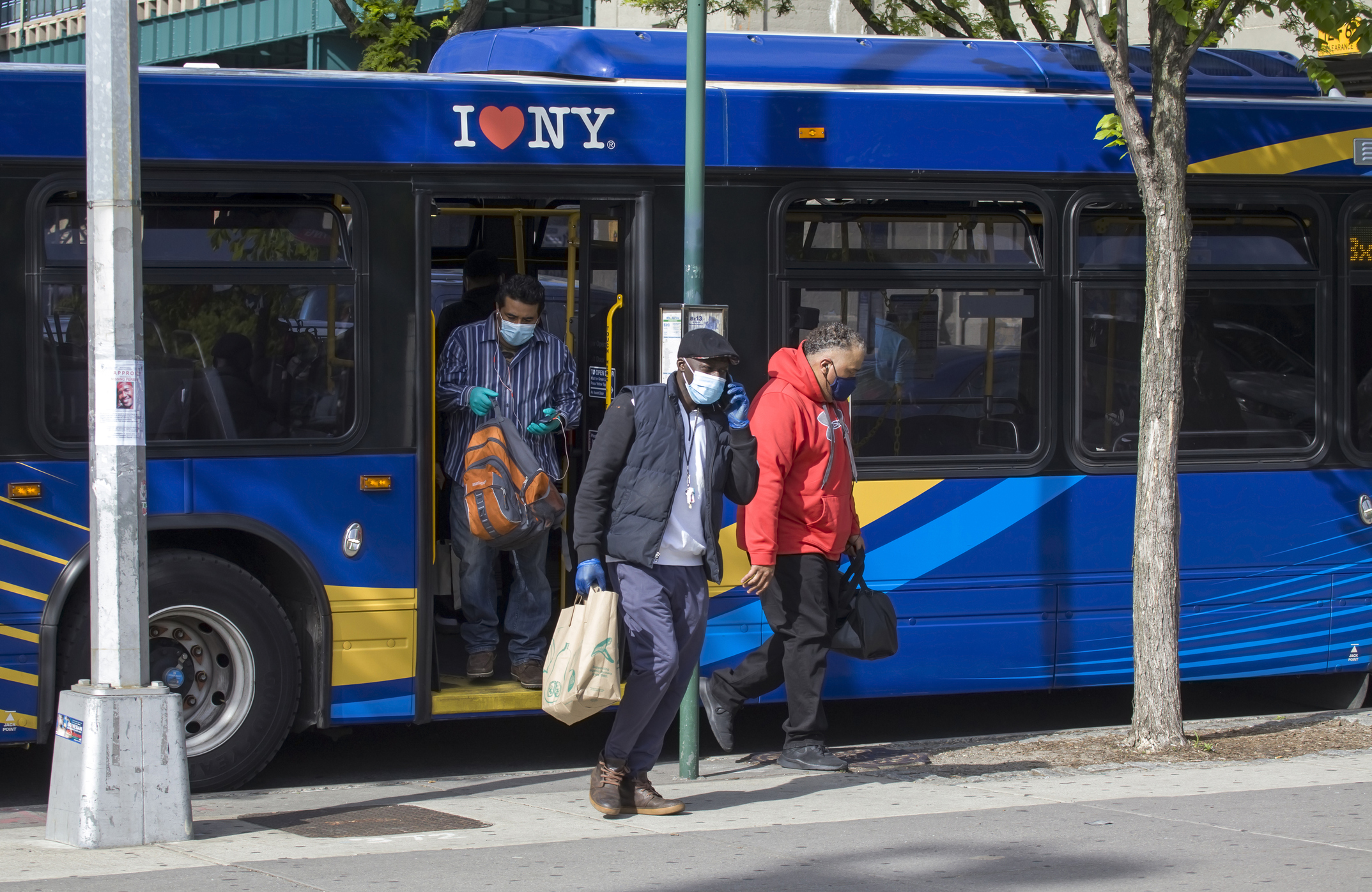 People leaving bus wearing masks during COVID-19 Bronx NY