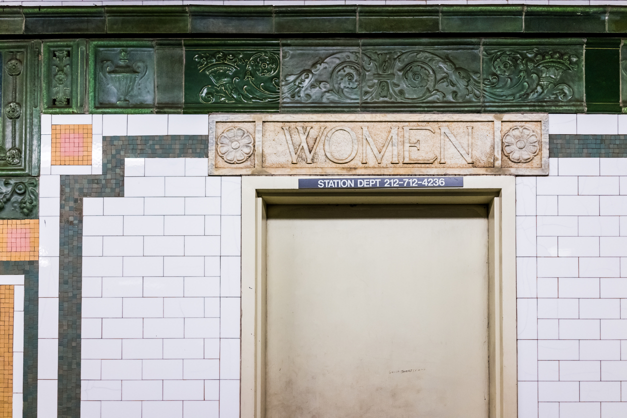women's bathroom door in subway station