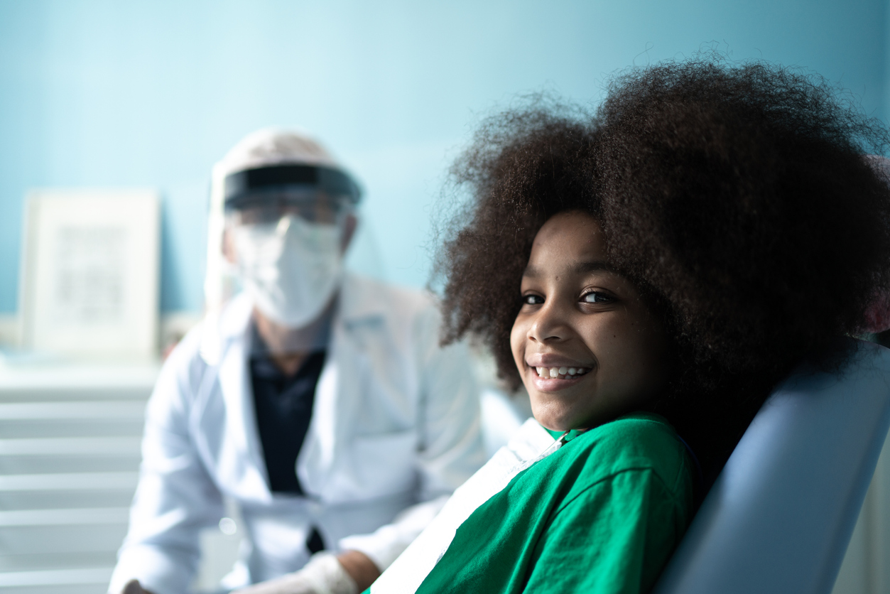 Young girl sitting in dentist's chair