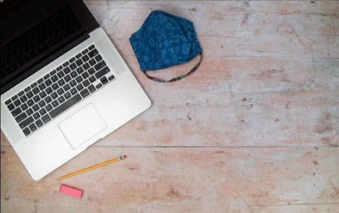laptop with face mask and pencil