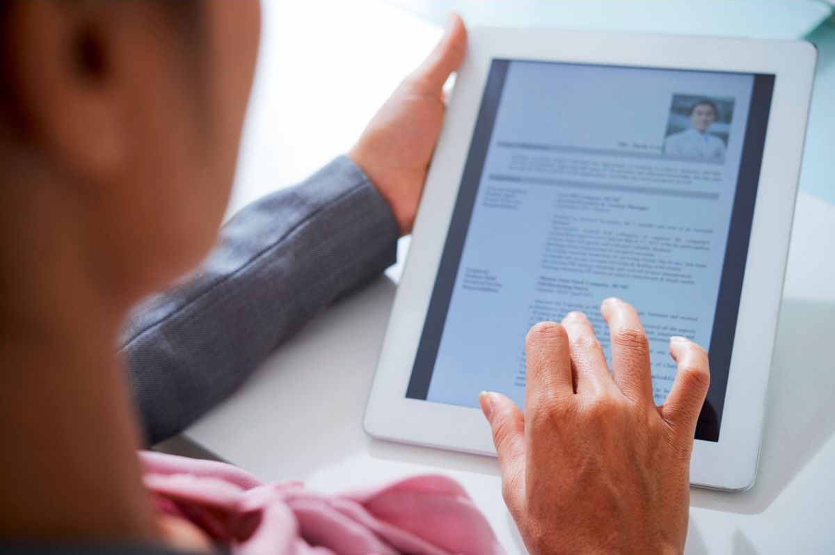 person looking at resume on a tablet