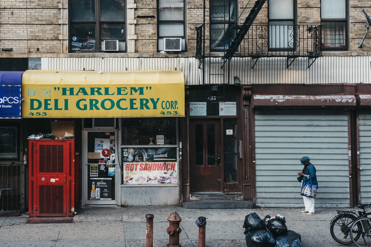 shuttered storefront and bodega