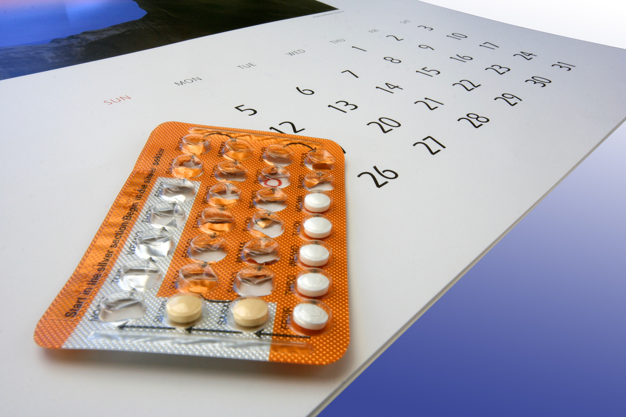 A mostly finnished packet of contraceptive pills lying on a calendar.