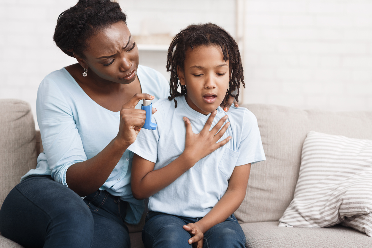 mother offering child asthma inhaler