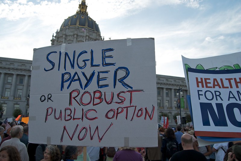 sign at protest demanding single payer or robust public option