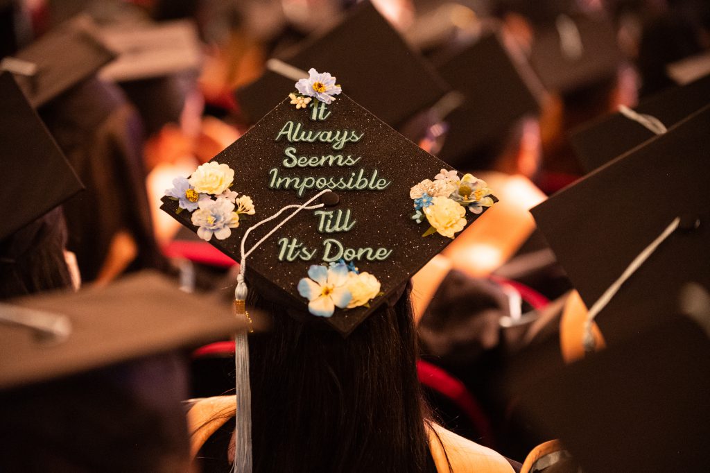 cap with "always seems impossible til it's done" written on it