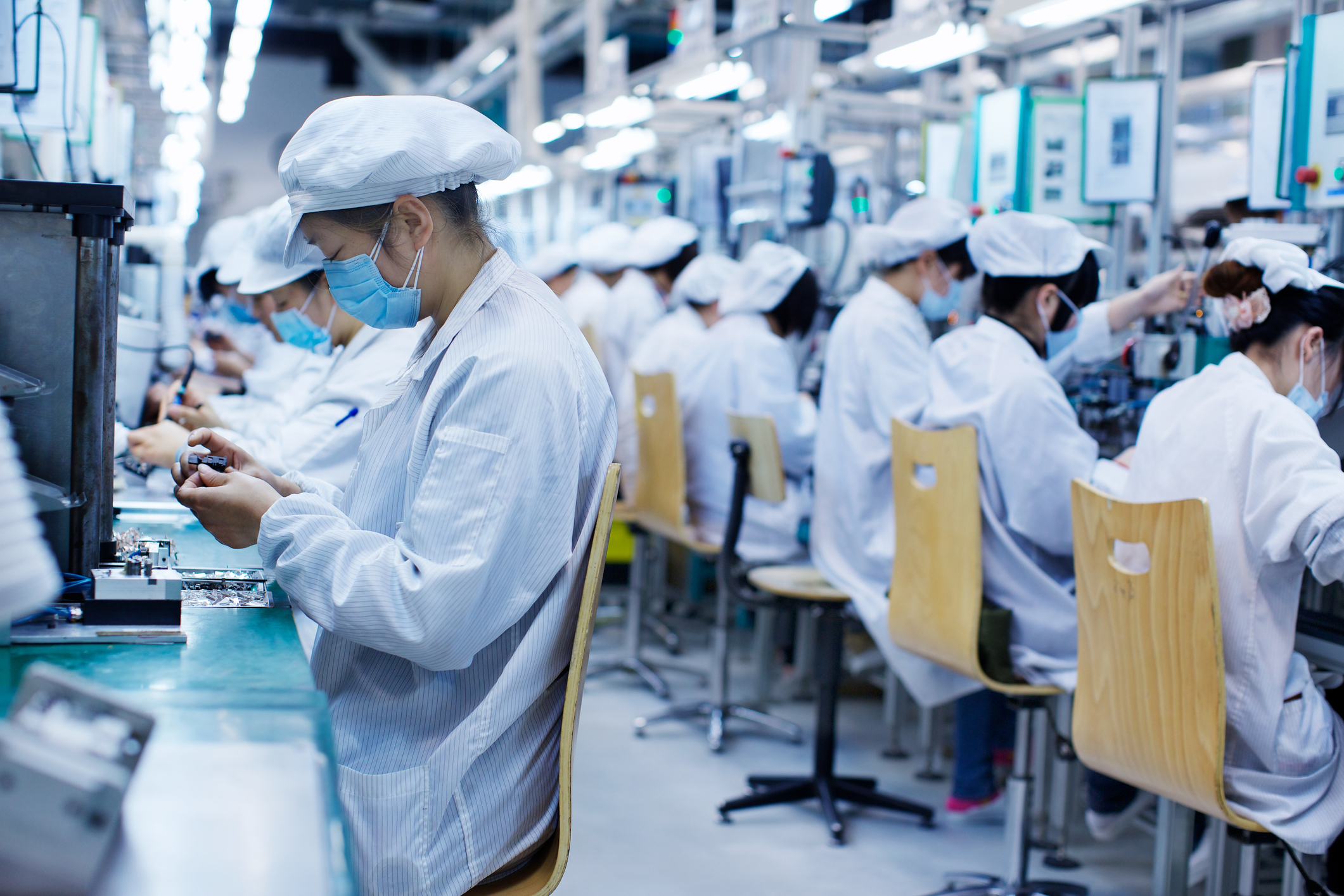 Group of workers at small parts manufacturing factory in China