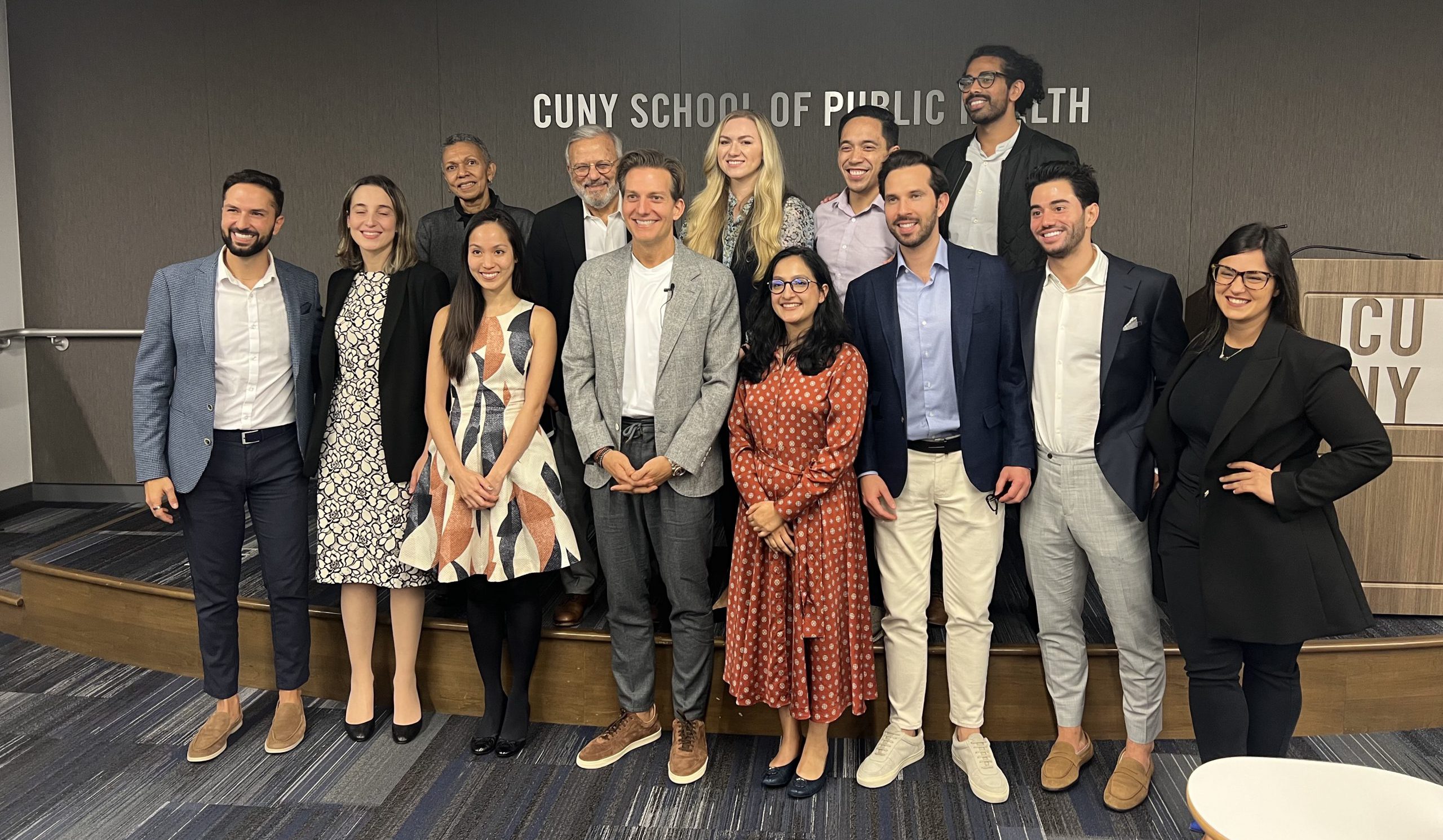 Dr. Michael Apa poses with CUNY SPH faculty, staff and Apa scholars