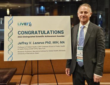 Professor Jeffrey Lazarus with award plaque