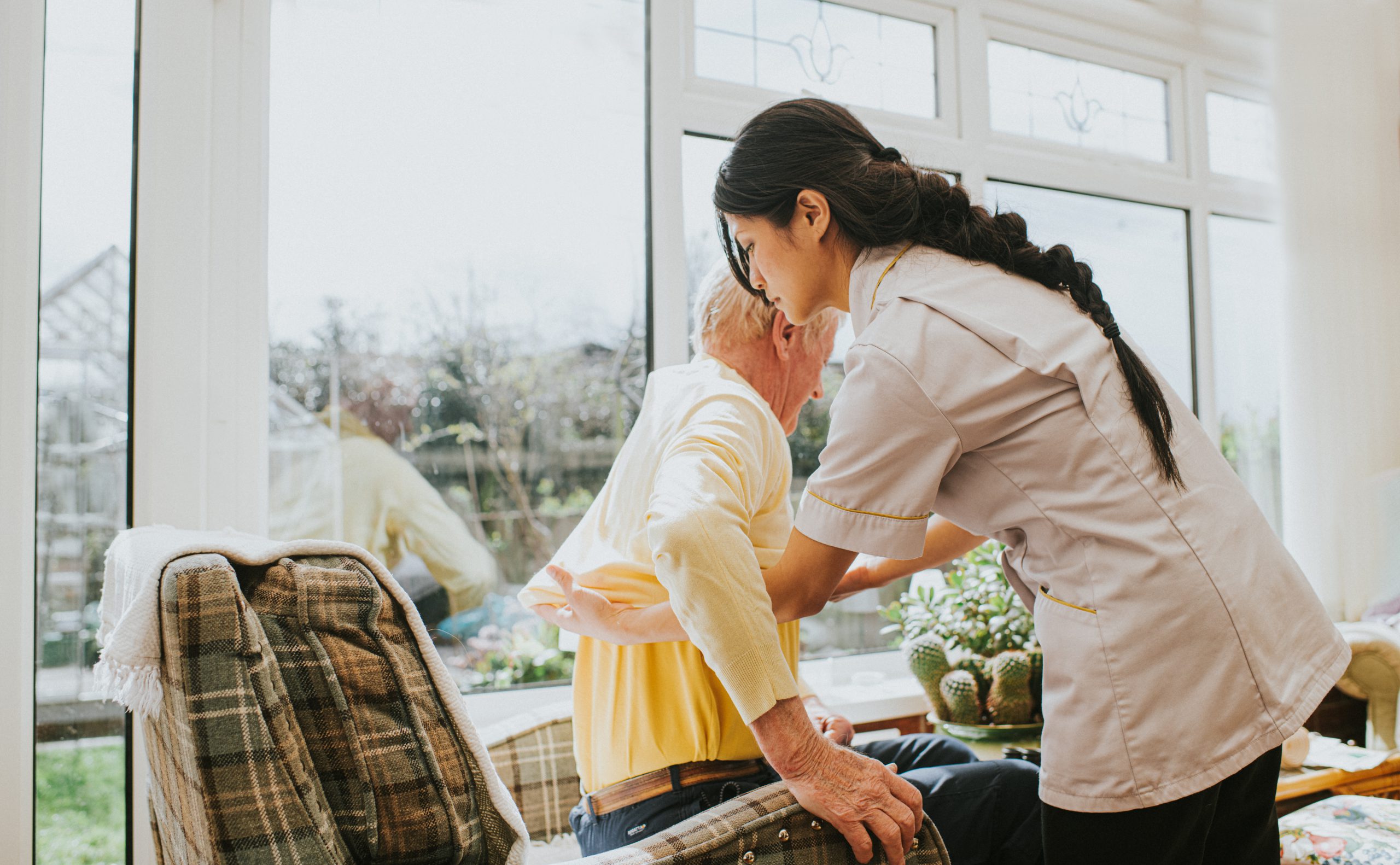 Home care aide assisting elderly person
