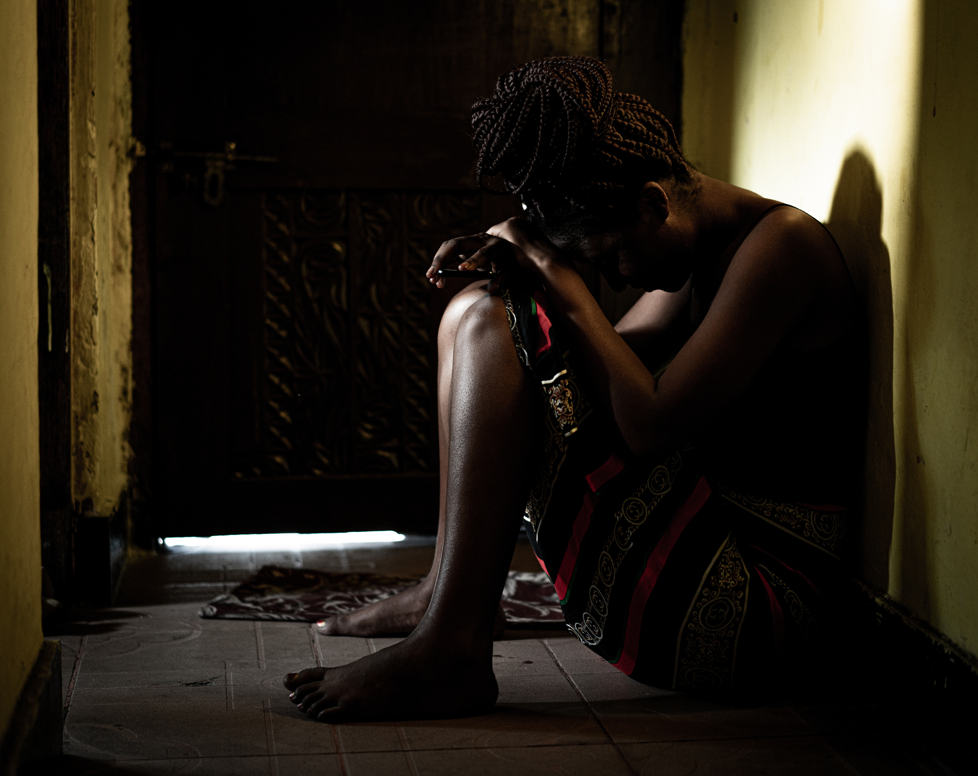 Silhouette of woman sitting in the dark