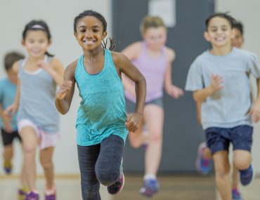 boys and girls run in gym