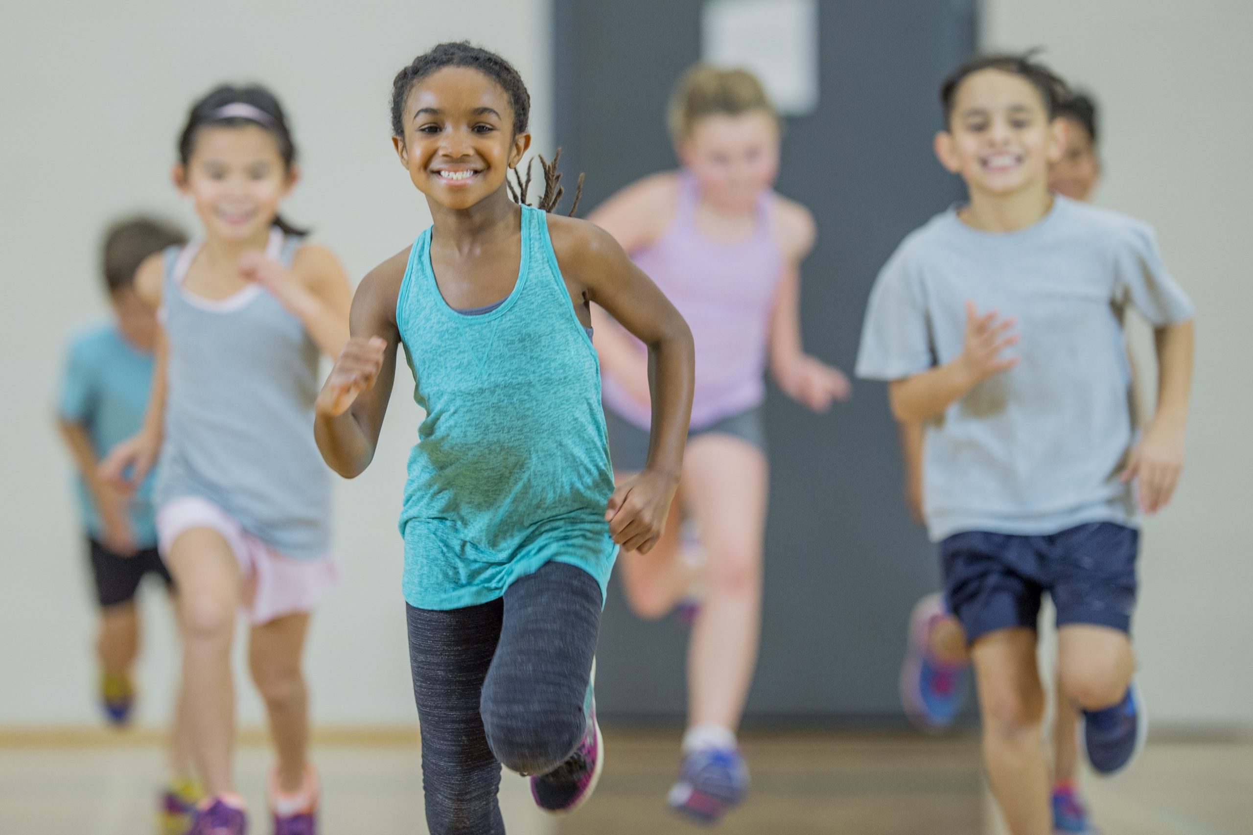 boys and girls run in gym