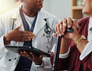 doctor speaking with older patient