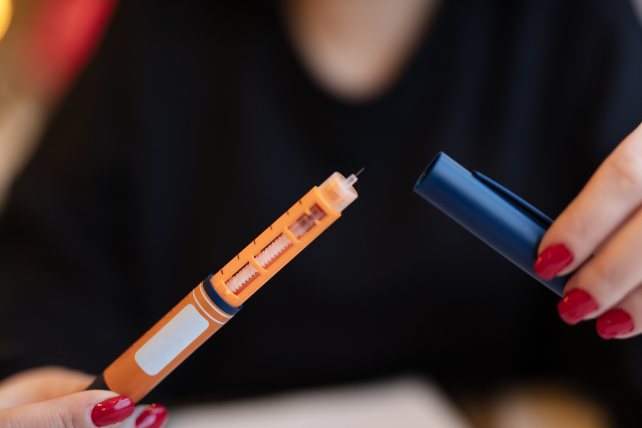 Woman holding an injection pen of semaglutide