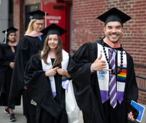 Graduates pose as they enter the Apollo theater
