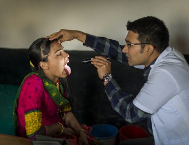 Doctor examines patient in Nepal
