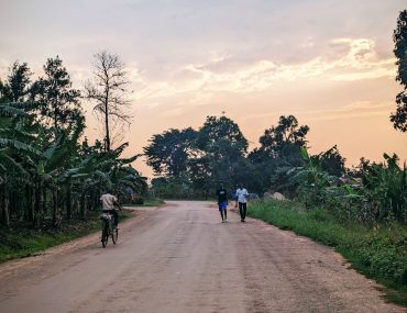 Young people walk along road in rural Uganda