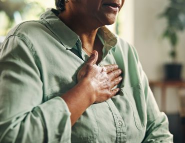 person with hand on chest