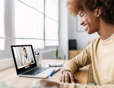 Young man has video visit with doctor