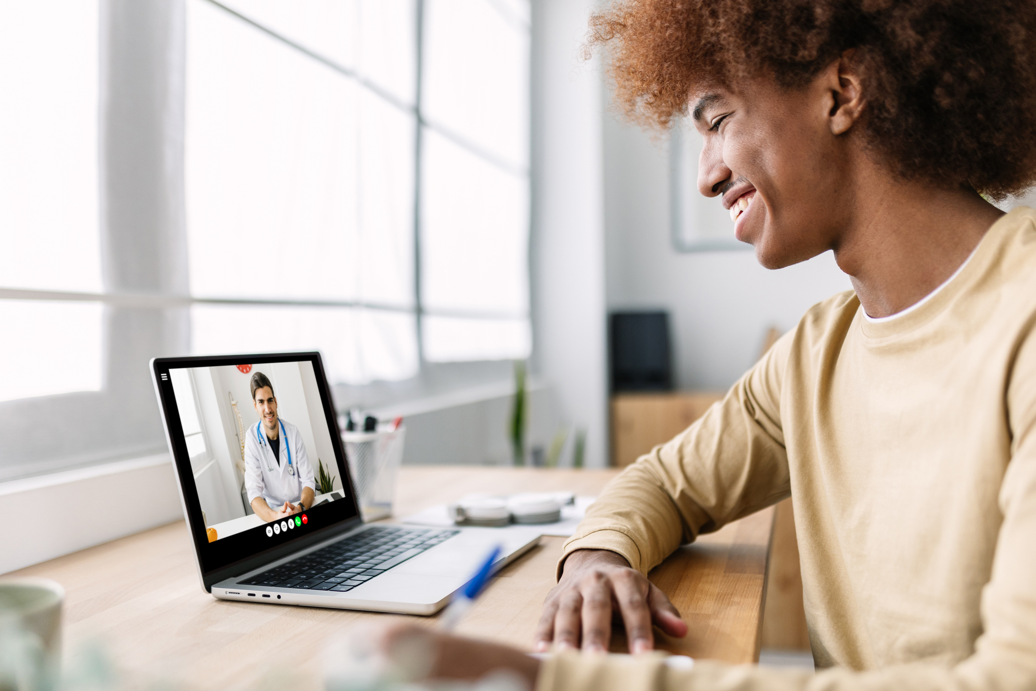 Young man has video visit with doctor