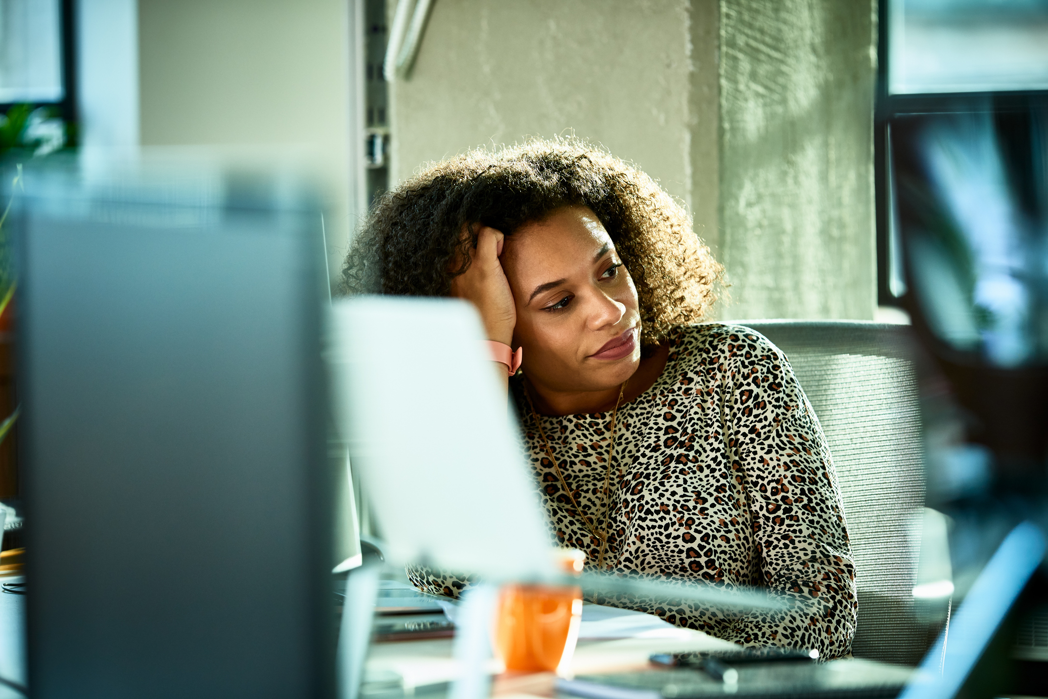 woman at desk looking frustrated