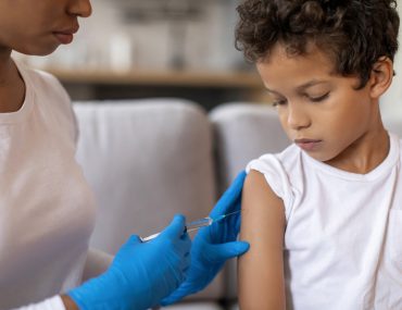 healthcare worker giving child vaccine