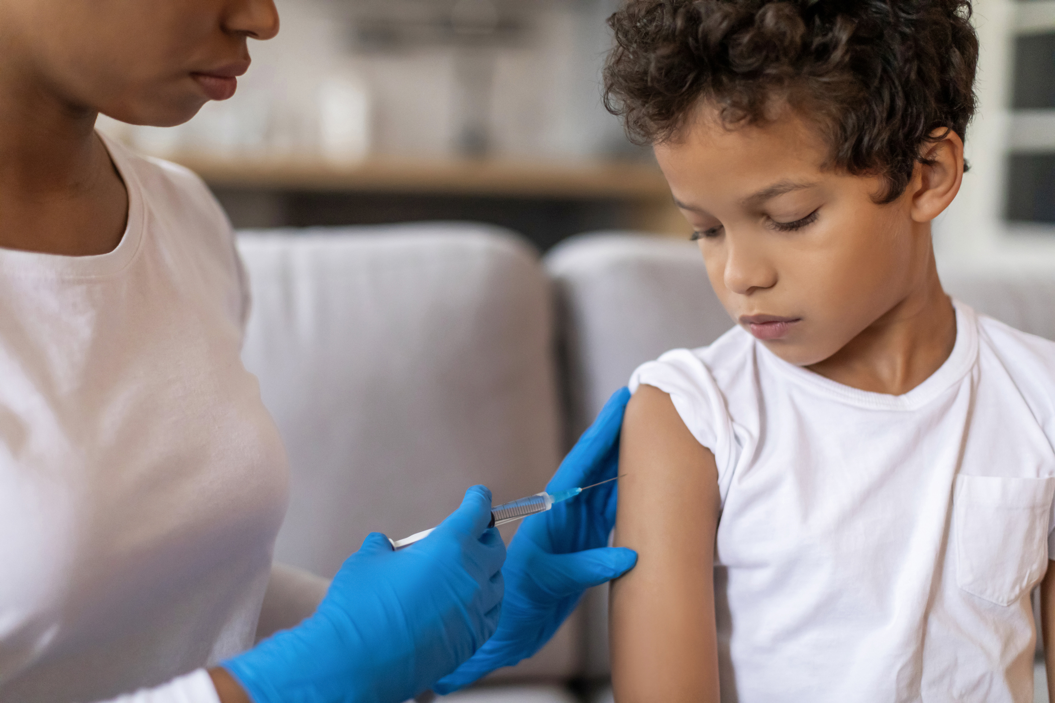 healthcare worker giving child vaccine