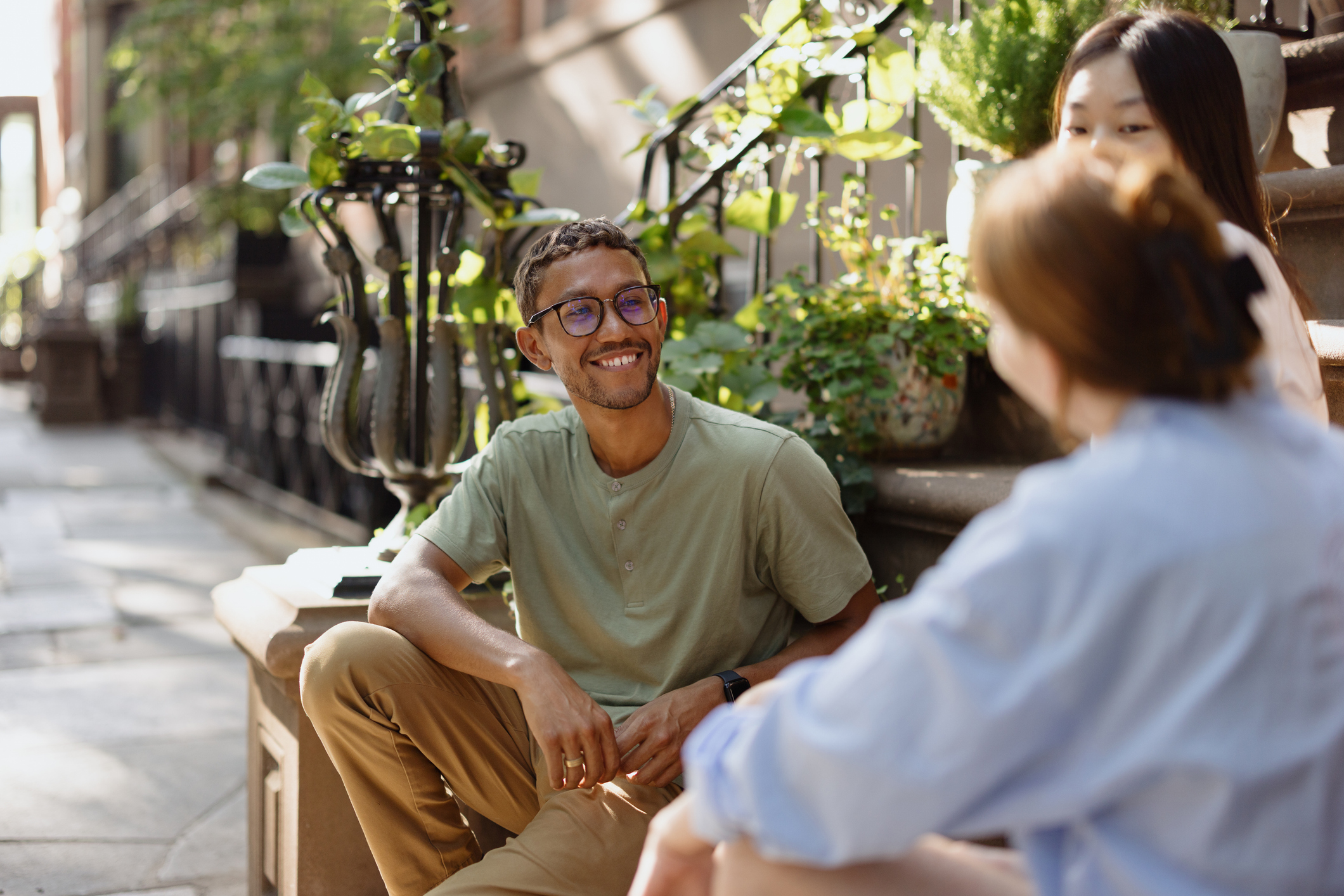 young people talk on stoop