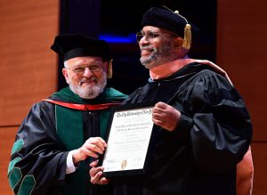 Dean El-Mohandes (left) presents honorary doctoral degree to Dr. Benjamin (right)