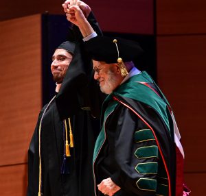 Valedictorian Xavier Gonzalez (left) and Dean El-Mohandes (right)